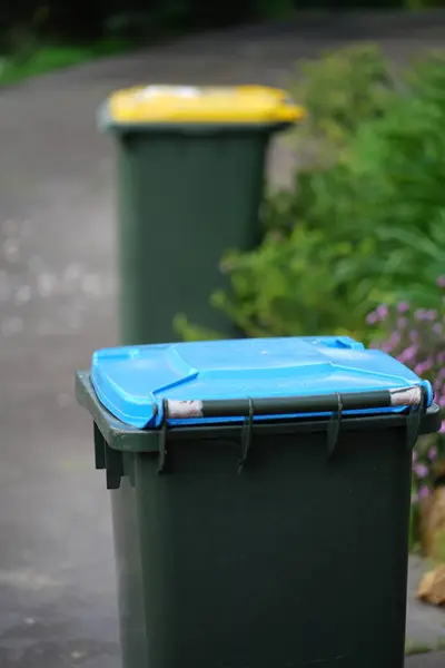 Australian home rubbish bins set provided by local council on back yard in Australian suburb. High quality photo