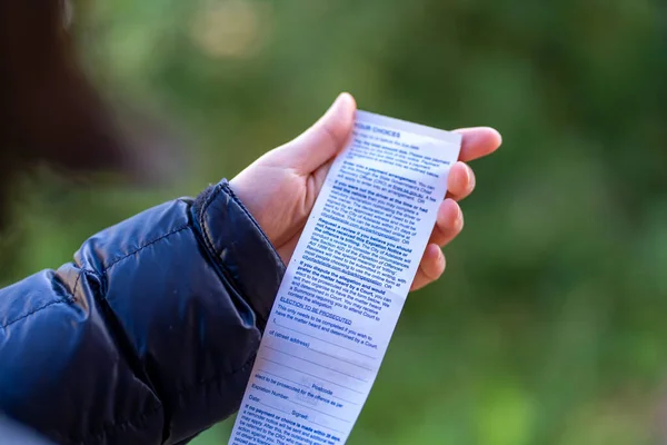 Hand holding a traffic violation ticket or fine notice. High quality photo
