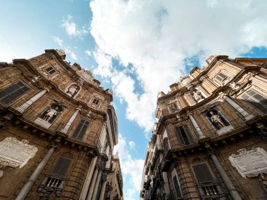 Quattro Canti, or officially Piazza Vigliena, in Palermo. Fontains represent different seasons. Buildings have sculptures of kings and saints.