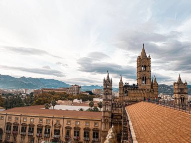 Close view at the dome and roof of Palermo Cathedral. The city is spread underneath. It's characterised by the presence of different styles.