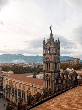 Close view at the dome and roof of Palermo Cathedral. The city is spread underneath. It's characterised by the presence of different styles.