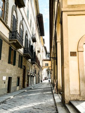 Narrow streets of an old town of Florence. No people. Buildings are of a colour of sand.