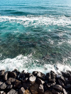 Turquoise water of the Mediterranean Sea near the shore of Italy. Beautiful colour of the calm waters, rocks far away near the horizons - perfect spot for relaxation.