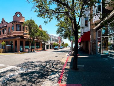 San Francisco 'nun cam ve beton gökdelenleri tepeden tırnağa görünüyor. Güneşli bir günde dev bina ışıldıyor, yollar az trafikle kesişiyor..