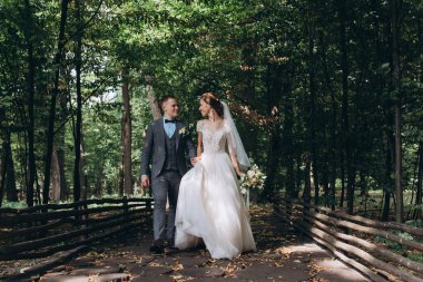 Parkta birlikte poz veren mutlu, genç, güzel bir çift.