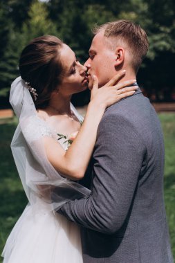 Mutlu genç bir çift parkta öpüşüyor.