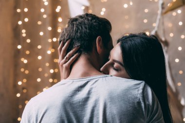 Genç ve güzel bir çift birbirine sarılıp öpüşüyor.