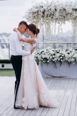 Mutlu gelin ve damat düğün günü sarılıyor ve dans ediyor. 