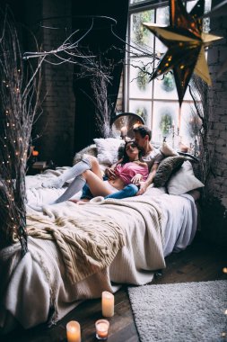 Yatakta genç ve güzel bir çiftin stüdyo fotoğrafı.