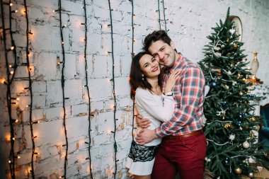 Güzel, mutlu, birbirine aşık genç bir çift sıcak bir odada kucaklaşıyorlar..                   