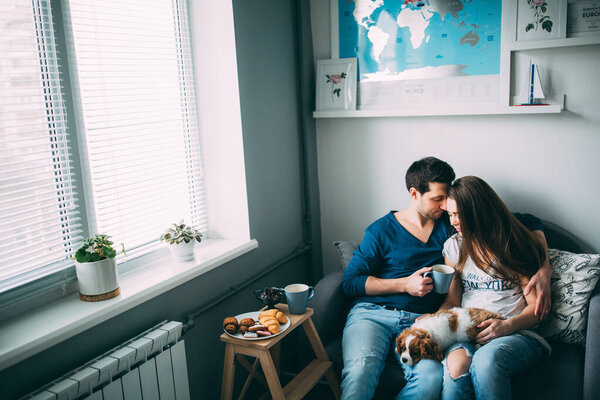 couple with a dog in the kitchen 