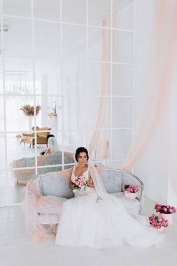Şık iç kısımda oturan gelinlik içindeki güzel genç gelin.        