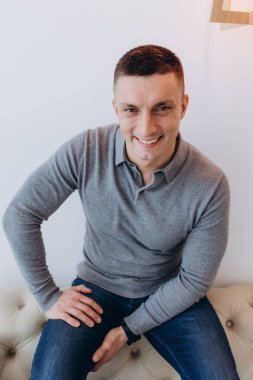 Genç adam stüdyoda poz verirken gündelik kıyafetler giyiyor.. 