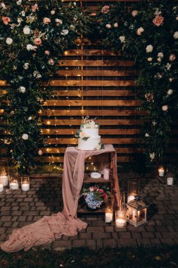 Çiçeklerle süslenmiş nefis düğün pastası.          