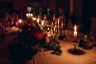 Düğün resepsiyonunda mum ve çiçeklerin yakın plan görüntüsü