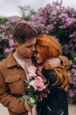 Mutlu çift baharda parkta poz veriyor. 