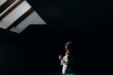 Beyaz bornozlu güzel gelinin portresi. Düğün sabahı evde.       