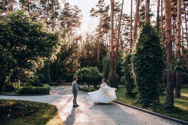 Genç ve mutlu bir çift yaz parkında yürüyor.          