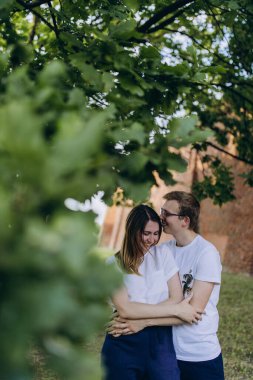 Genç ve aşık bir çift şehirde sarılıyor.