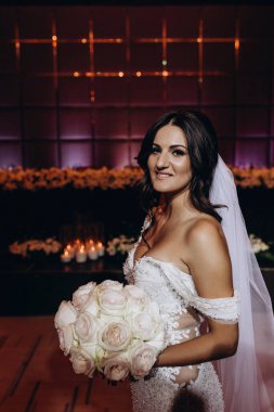 Beyaz gelinlik içindeki güzel gelinin portresi.              