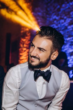 Mutlu genç damat düğün törenine bakıyor..