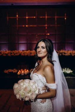 Beyaz gelinlik içindeki güzel gelinin portresi.              