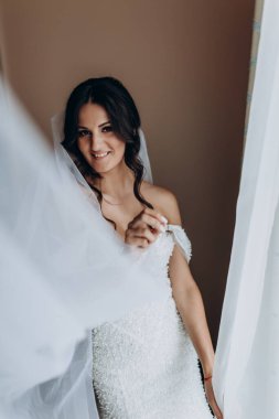 Gelinlikli güzel gelin kameraya gülümsüyor.