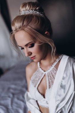 Güzel genç gelin düğün sabahı yatak odasında.       