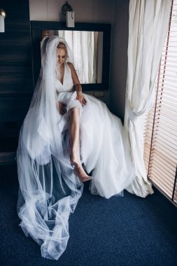 Güzel genç gelin düğün sabahı yatak odasında.       