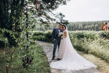 Gelin ve damat dışarı çıkıp fotoğraf çekiyorlar. 