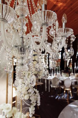 Çiçek dekoru ve kristal avizesi olan güzel bir düğün iç mekanı.