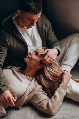 Güzel bir çift evde dinlenirken birbirlerine bakıyorlar.