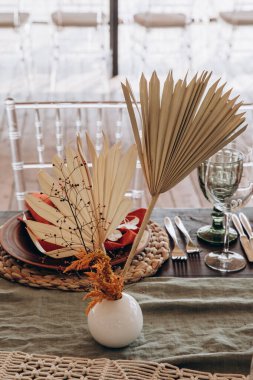 Masanın üzerinde çiçekler ve süslemeler olacak.