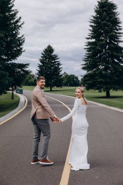 Genç ve güzel bir çift parkta yürüyor..