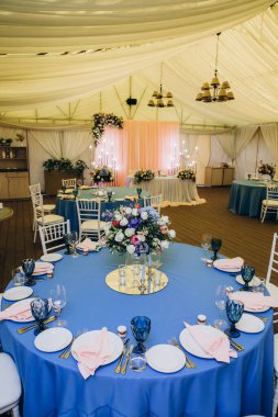 Düğün resepsiyonunda çiçeklerle süslenmiş zarif bir masa.                 