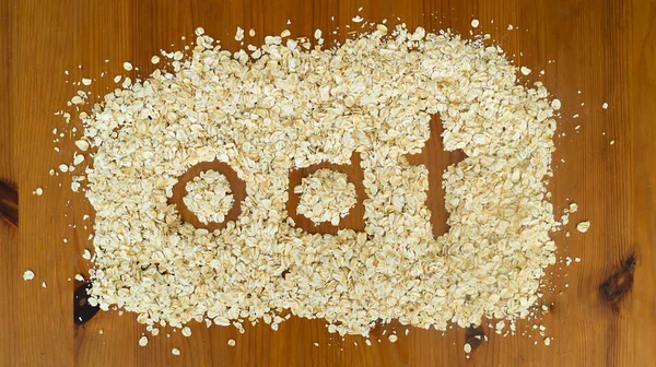 Oat flakes rolled oats on wooden table. Top view. Healthy food and lifestyle, vegetarian and raw food concept. High quality photo