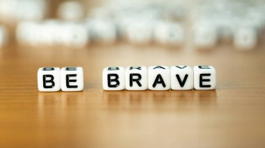 Be brave slogan in white block letter beads . High quality photo clipart