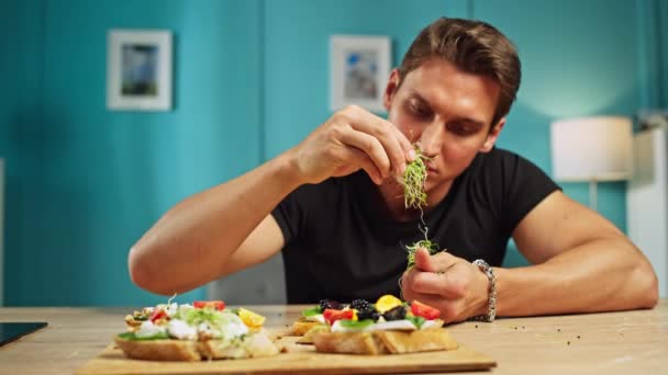 Caucasian Man Preparing Sandwiches Kitchen Home Guy Puts Avocado Vegetables — Vídeo de Stock