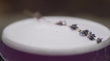 Close-up of a beautiful pre-painted purple cocktail on a bar counter. Alcoholic drinks for a party in a restaurant. High quality 4k footage