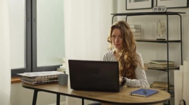 Slow motion video of a woman working at a computer from home. A girl clicks on a laptop keyboard while working remotely online. A businesswoman is preparing a report. High quality 4k footage