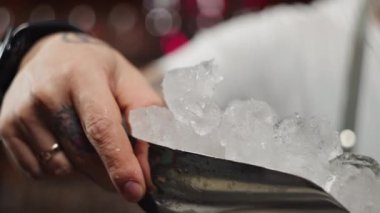 The bartender throws ice into the shaker. the first steps in making a cocktail. a cocktail that blows with coolness. High quality 4k footage