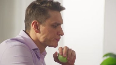 The businessman leans back in the office chair and throws the ball uphill. Tortured manager at work in the office took a break. A hard days work. High quality 4k footage