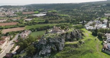 Aerial view of the ancient church on the rock in Cyprus. A religious building on a mountain in a beautiful landscape. Ancient architecture. High quality 4k footage