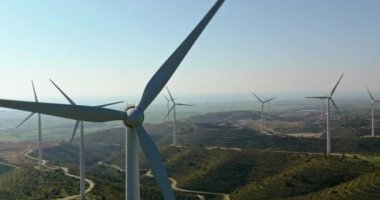 windmills that extract electricity from the force of the wind. Close-up of windmill blades in the mountains. A beautiful landscape and ecological production of electricity at the station. 