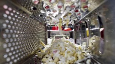 Slow-motion video of grating eggs with a grater in the kitchen. A beautiful cinematic video of preparing ingredients for cooking. High quality 4k footage