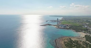 Aerial view coastline with sandy beaches on the seashore on the island of Cyprus. A beautiful landscape with waves of the sea, a place of relaxation and rest in a fabulous place. High quality 4k 