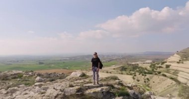 Aerial view woman conquered the top of the mountain with a backpack. Haikin active recreation and outdoor sports in the mountains. High quality 4k footage