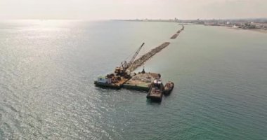 Aerial view urban industrial landscape with a crane on a barge in the sea. Work at sea. High quality 4k footage