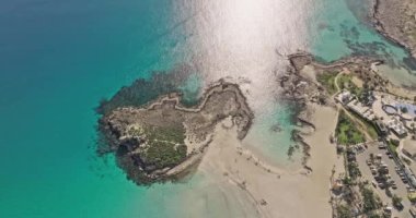 Aerial view of the seashore on the beach in Ayia Napa, Cyprus. Beautiful landscape of the city with hotels and beach area, resorts. High quality 4k footage