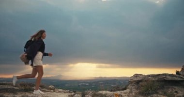 Caucasian athletic woman with her daughter hiking in the mountains. Helping each other while traveling through mountain ranges. Lets take support of the time spent together. High quality 4k footage